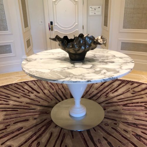 A marble table with a vase on top of it