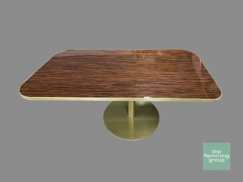 A table with a brown top and gold base.