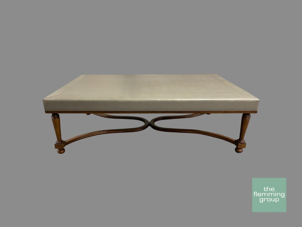 A large rectangular coffee table with metal legs.