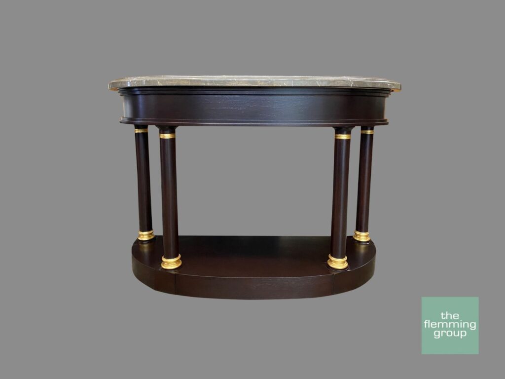 A table with two legs and a marble top.