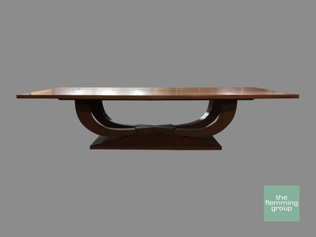 A wooden table with a black base and brown top.