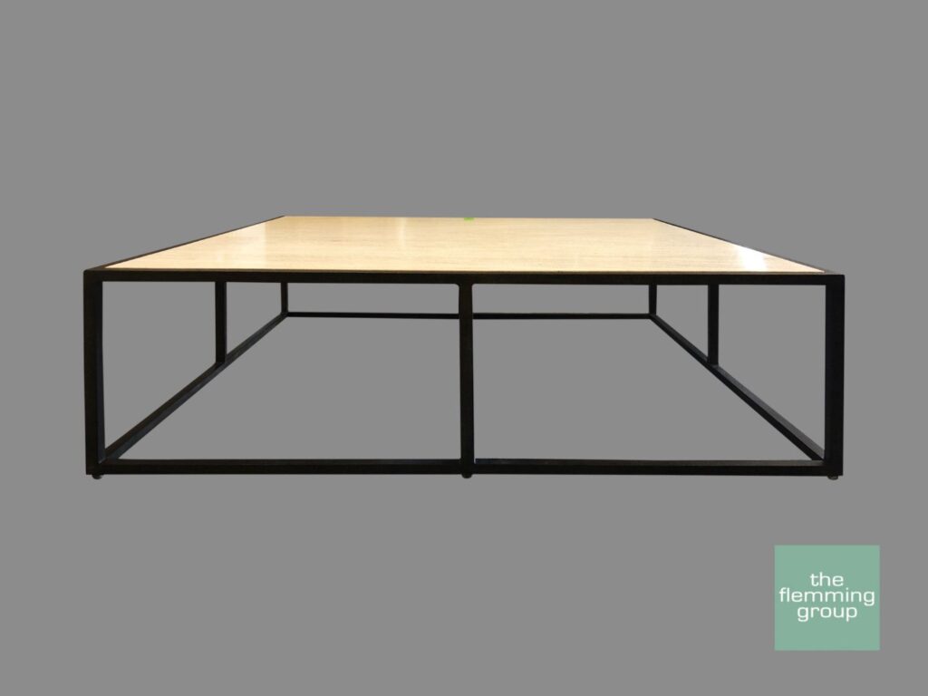 A square coffee table with metal legs and a wooden top.