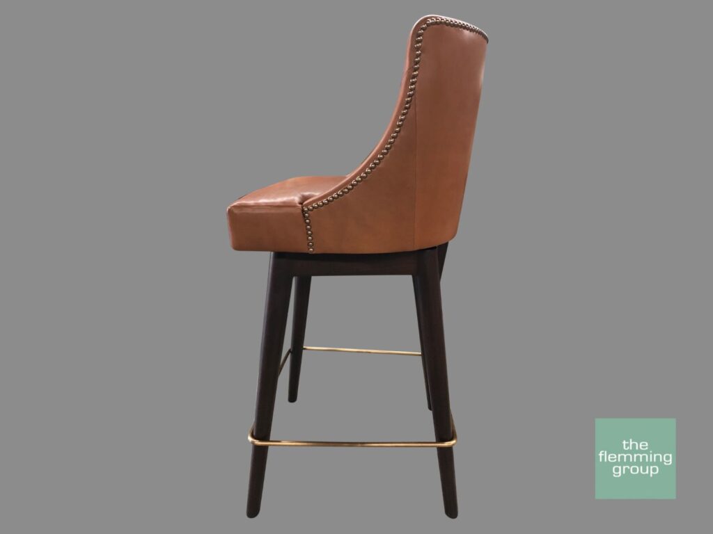 A brown leather bar stool with metal legs.