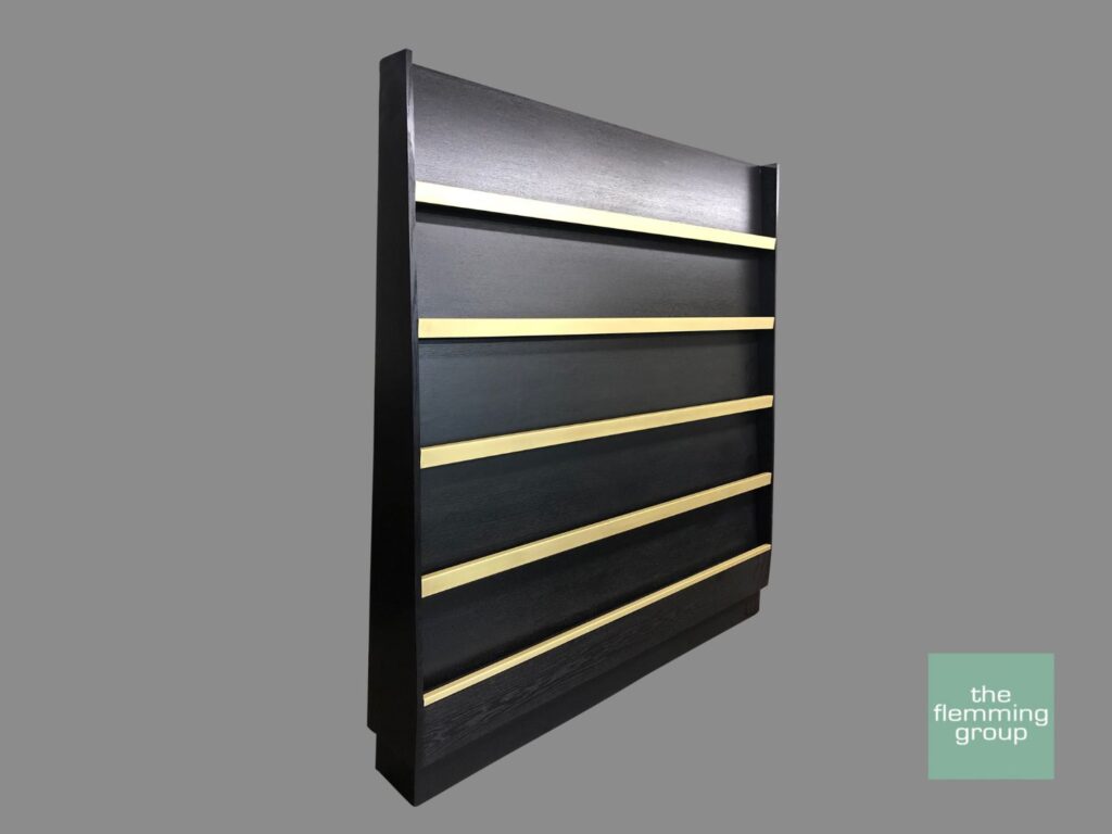 A black and gold wall mounted shelf