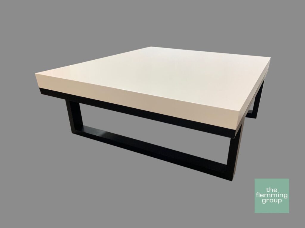 A white table with black legs on top of it.