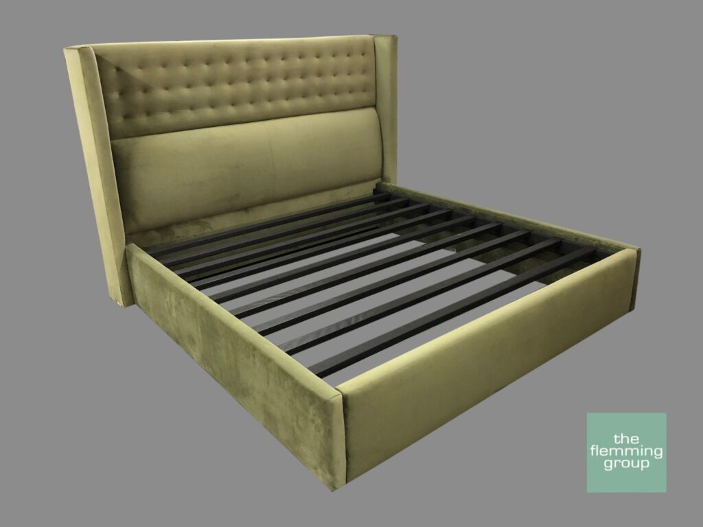 A bed with a green headboard and footboard.