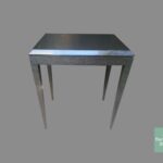 A table with metal legs and a black top.