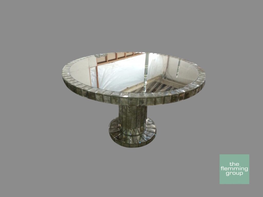A round table with a mirror on top of it.