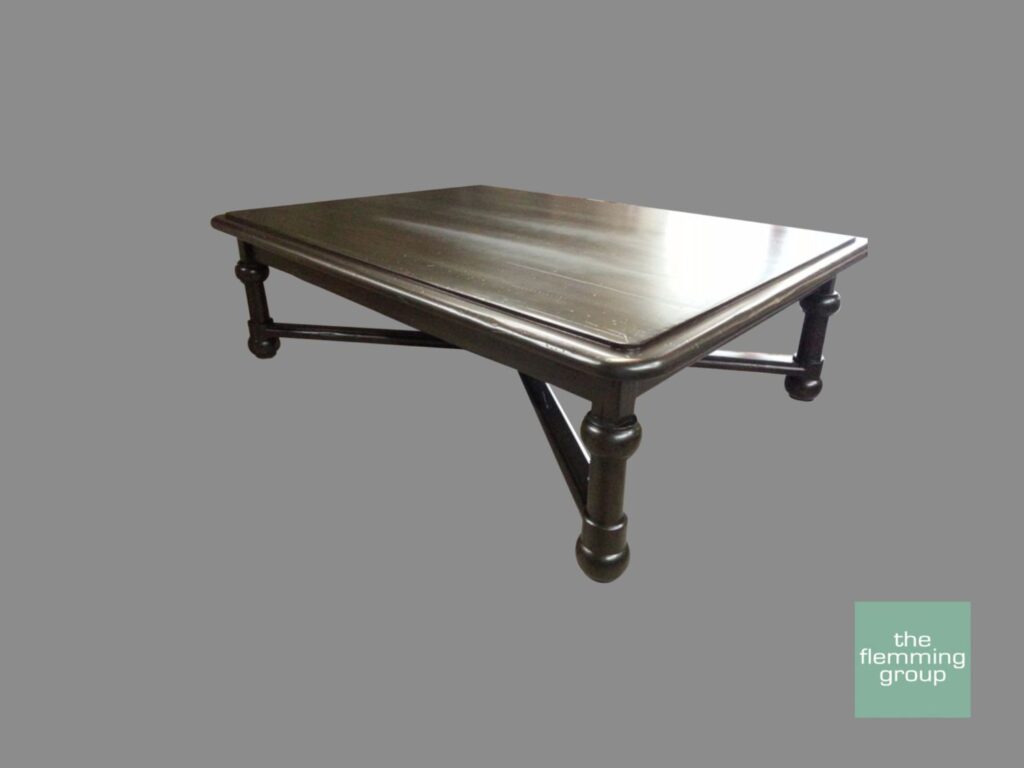 A metal table with a silver top and black legs.