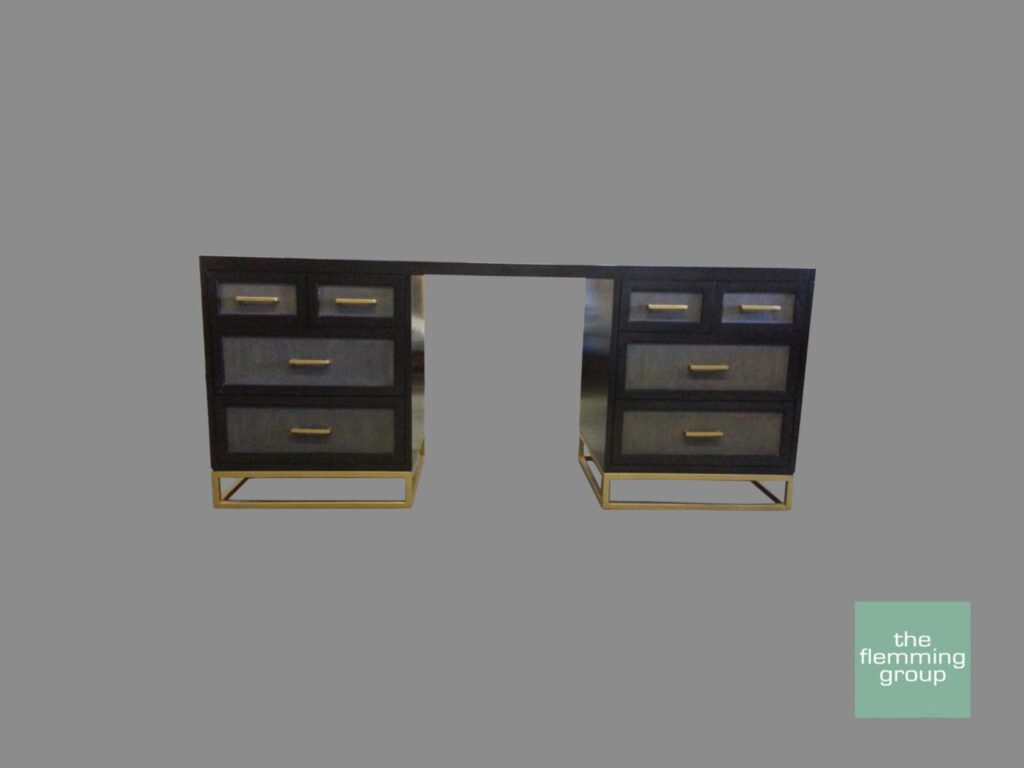 A computer desk with drawers and a gold frame.
