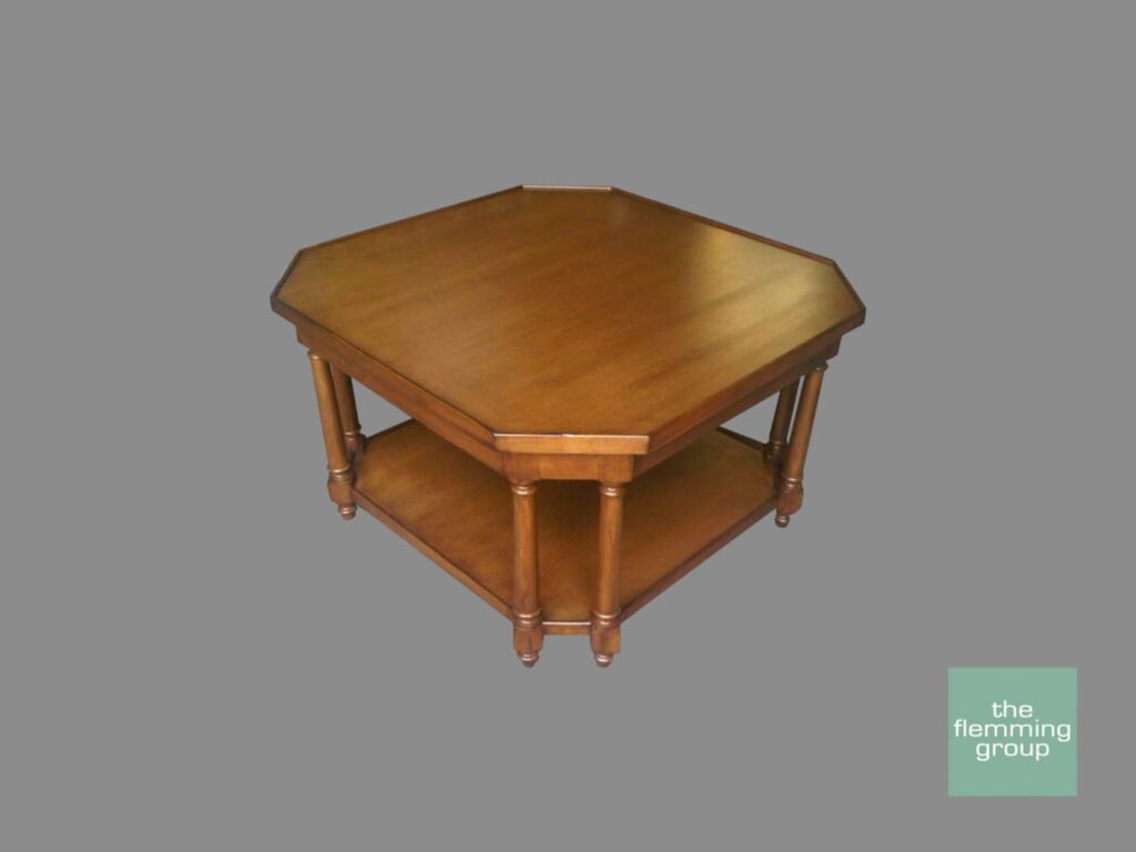 A wooden table with two shelves and a round top.