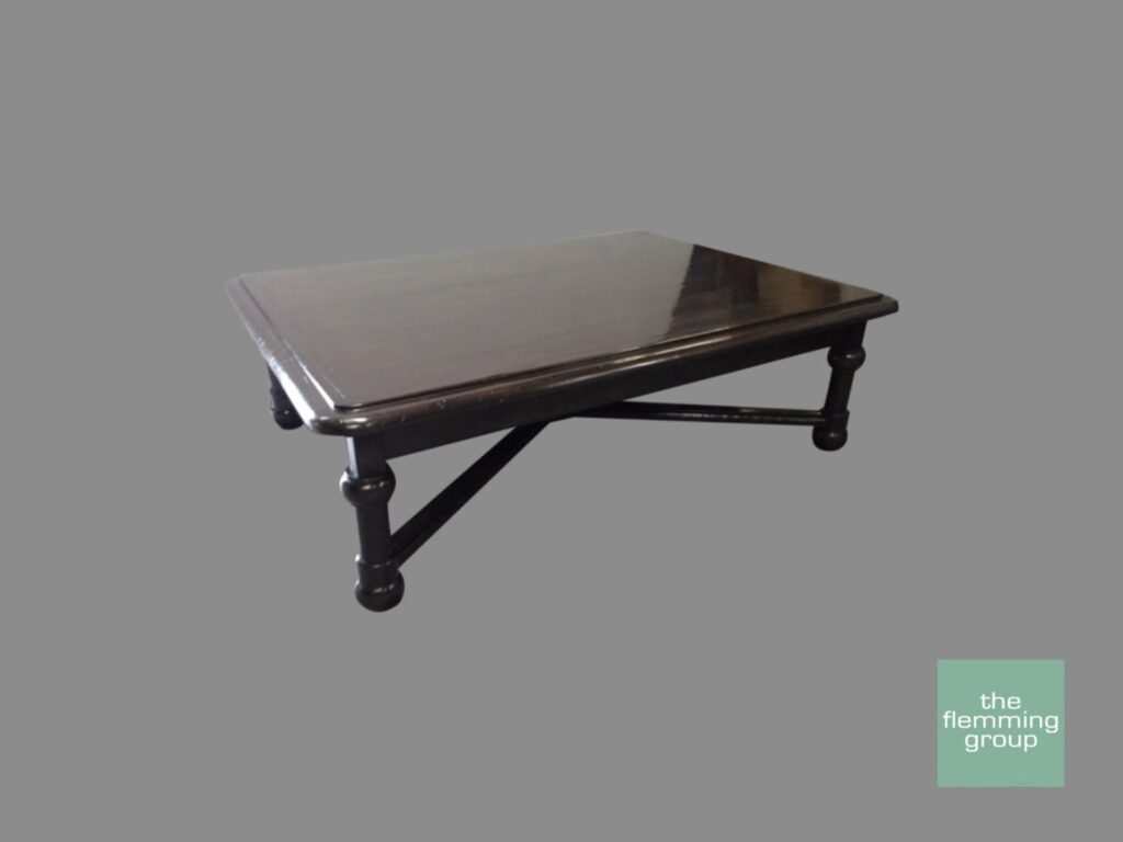 A black coffee table with a glass top