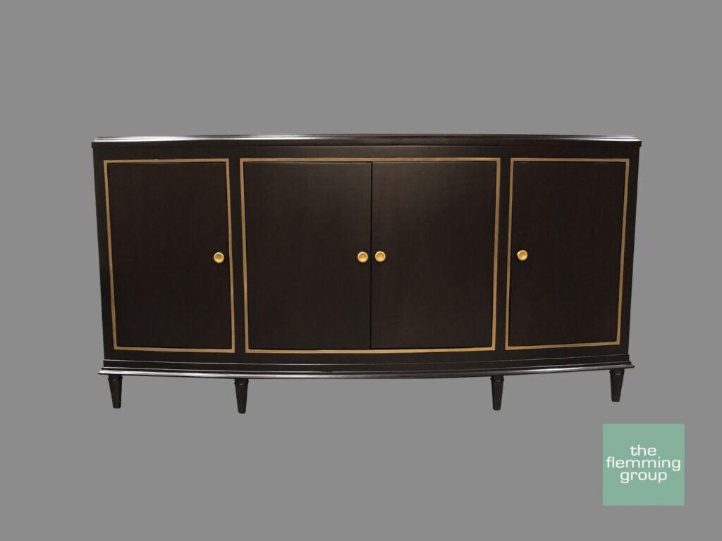 A black and gold sideboard with four doors.