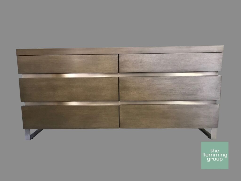 A dresser with six drawers and metal legs.