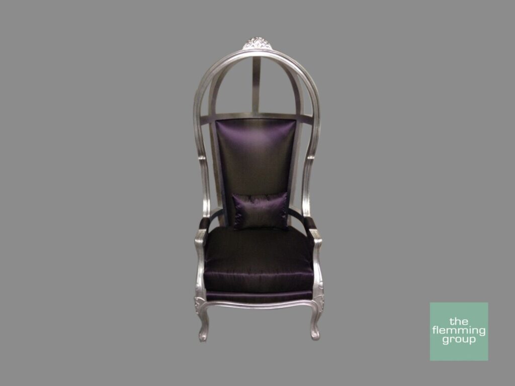 A black and silver chair with a purple cushion.