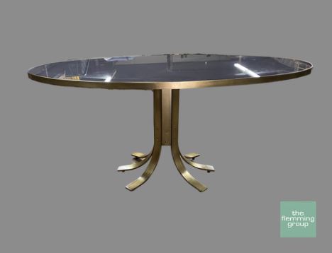 A table with a metal base and glass top.
