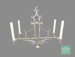 A chandelier with six candles in it.
