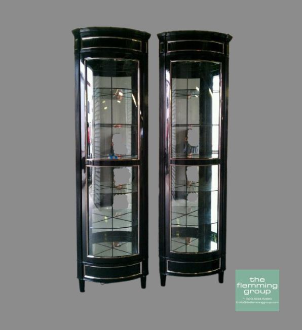Two black cabinets with glass doors and a silver handle.