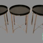 A set of three black tables with metal legs.