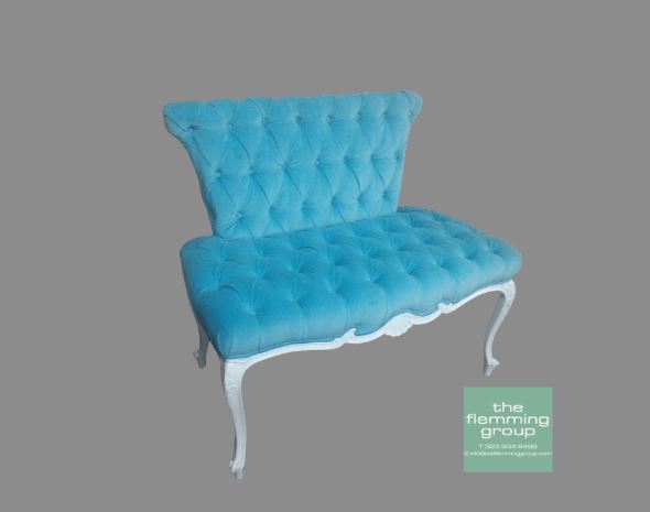 A blue bench with white legs and tufted back.