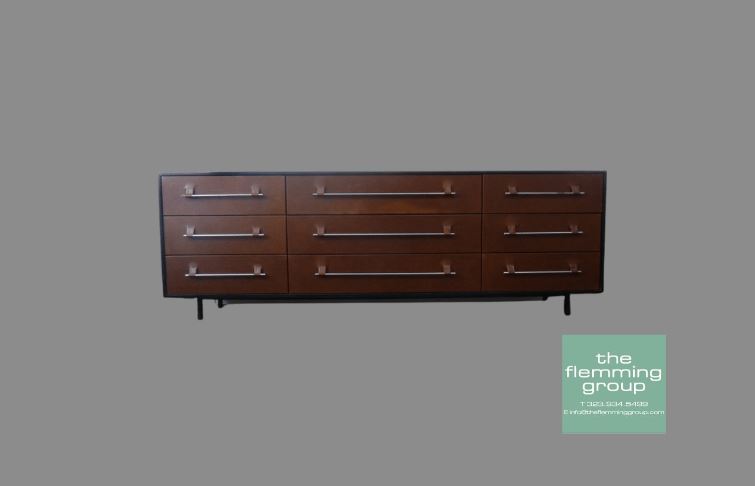 A brown dresser with metal handles and legs.