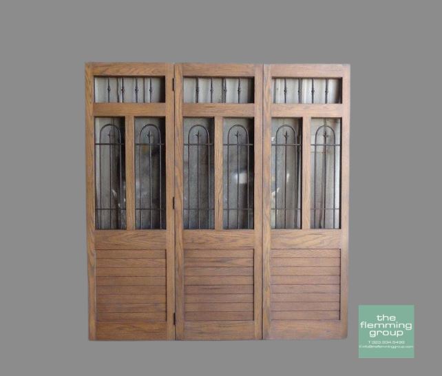 A set of three wooden doors with glass windows.