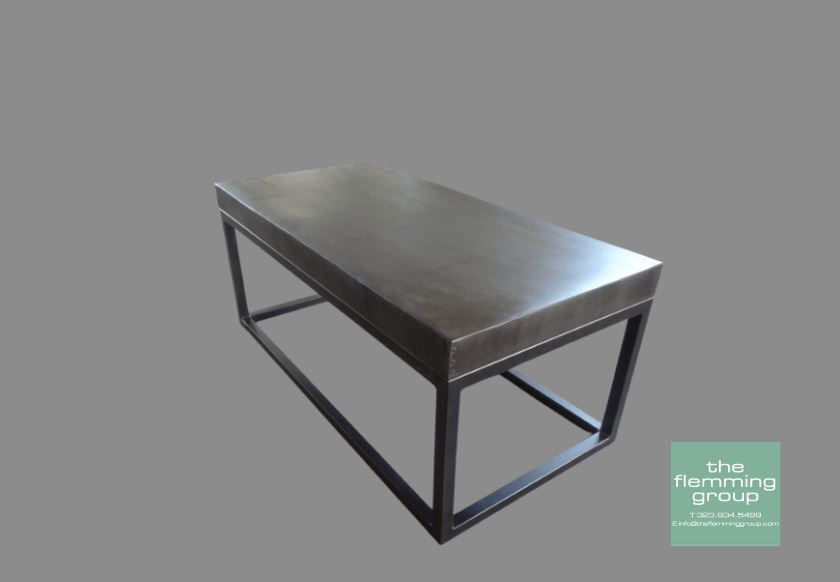 A table with metal legs and a concrete top.